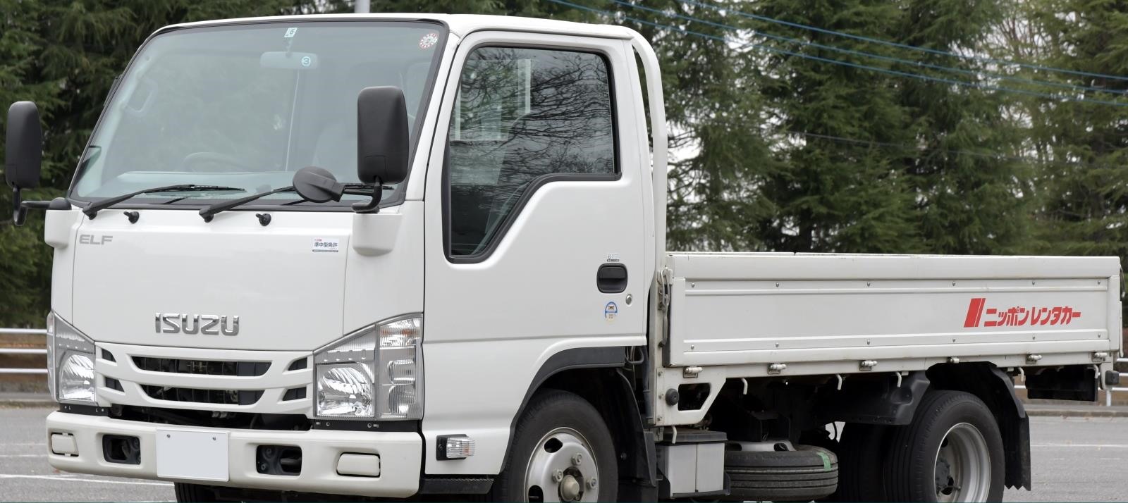 White Isuzu flatbed truck